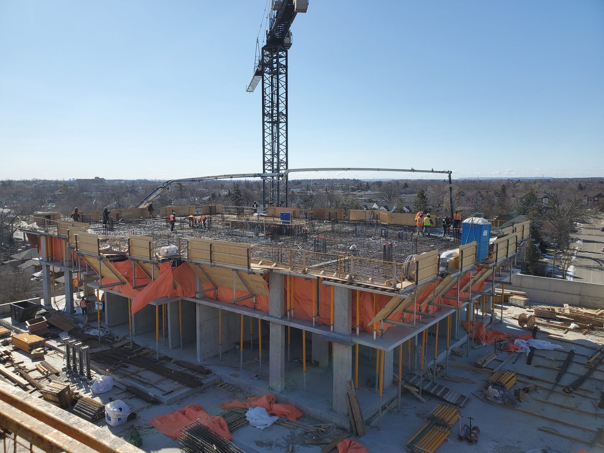 Aerial view of a Delso Group concrete formwork project with crane and crew