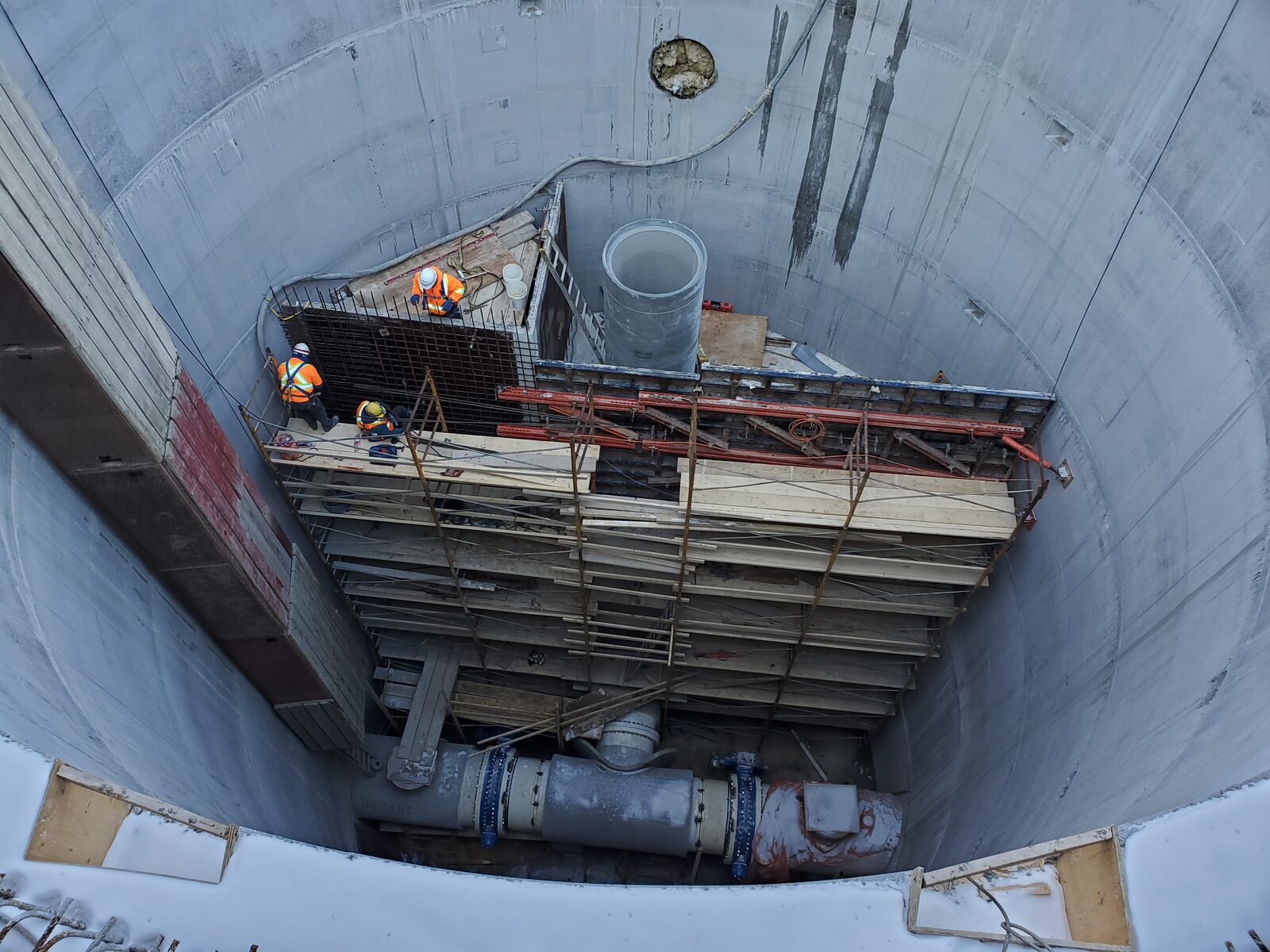 Delso Structures crew working on a deep concrete watermain installation